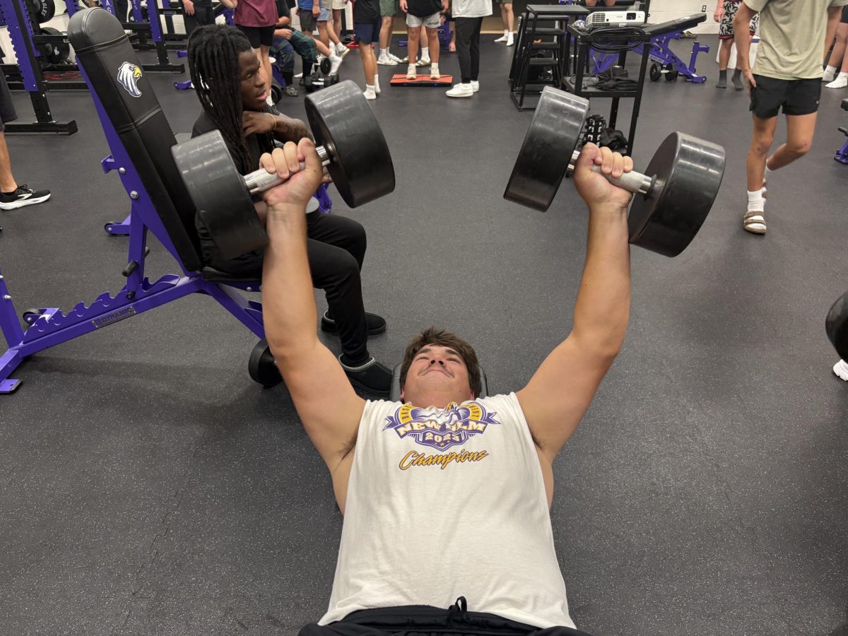Junior Tanner Backer lifting during a practice