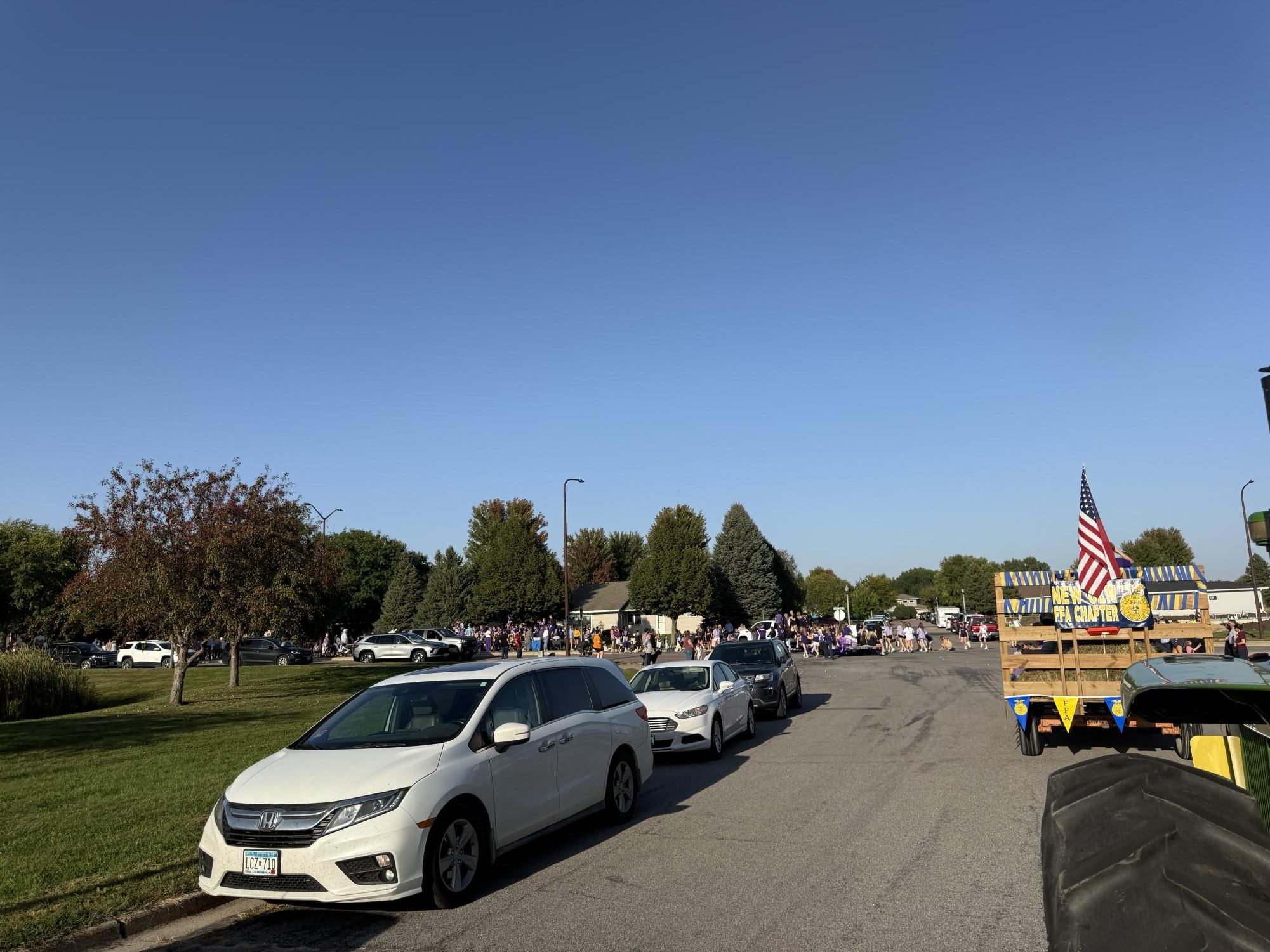 Crowds cheer on from the sidewalks as royalty, sports, and organizations parade across Highland Avenue.