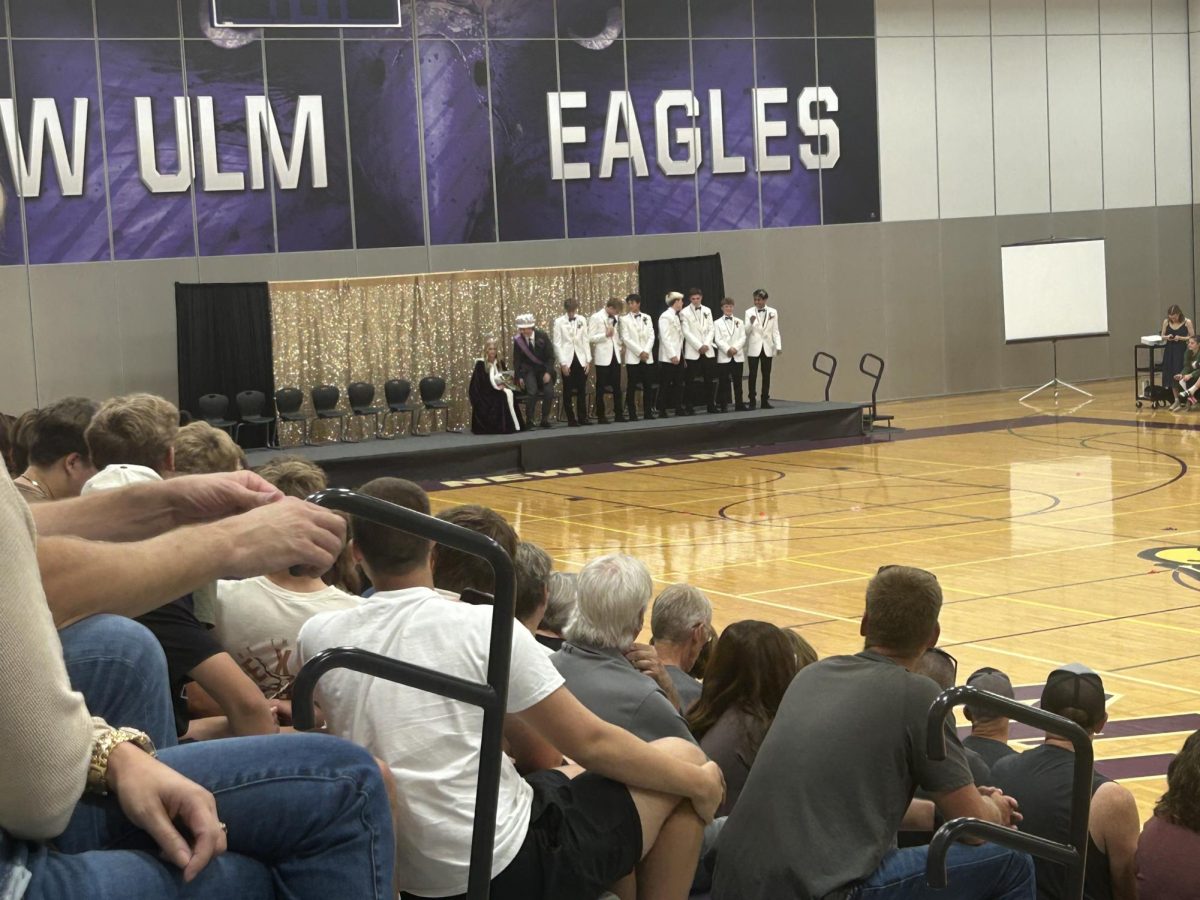 Left to Right. Daniel Brownfield, Brady Dennis, Collin Forstner, Dirk Haynes, Zach Hubbard, Tegan Kral, and Jackson Ocampo are all lined up alongside 2024 Homecoming King and Queen Ramsey Hopp and Cullen Slette, Monday Night at Coronation for the crowning of NUHS new Homecoming King.