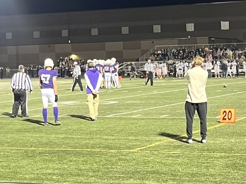 Brady Dennis (Right) takes pictures during the New Ulm v. St.Peter football game