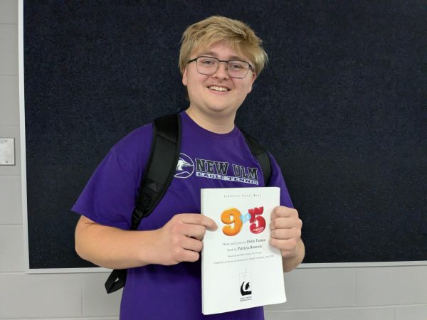 Senior Everett Brown holding the script for 9-5.