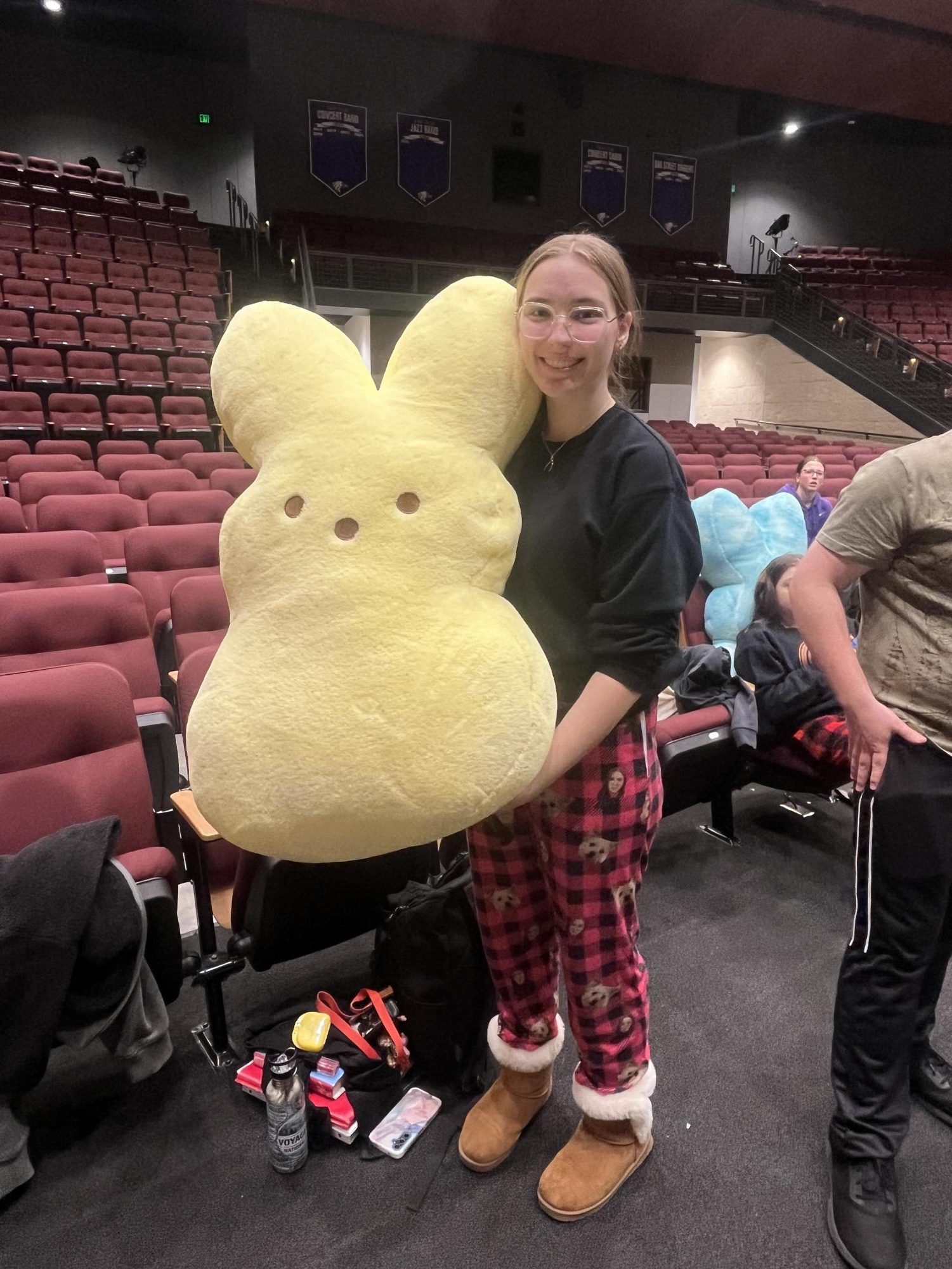 Senior Bronwyn Schlagel poses with her peep stuffed animal during pajama day practice while prepping for the musical 9 to 5