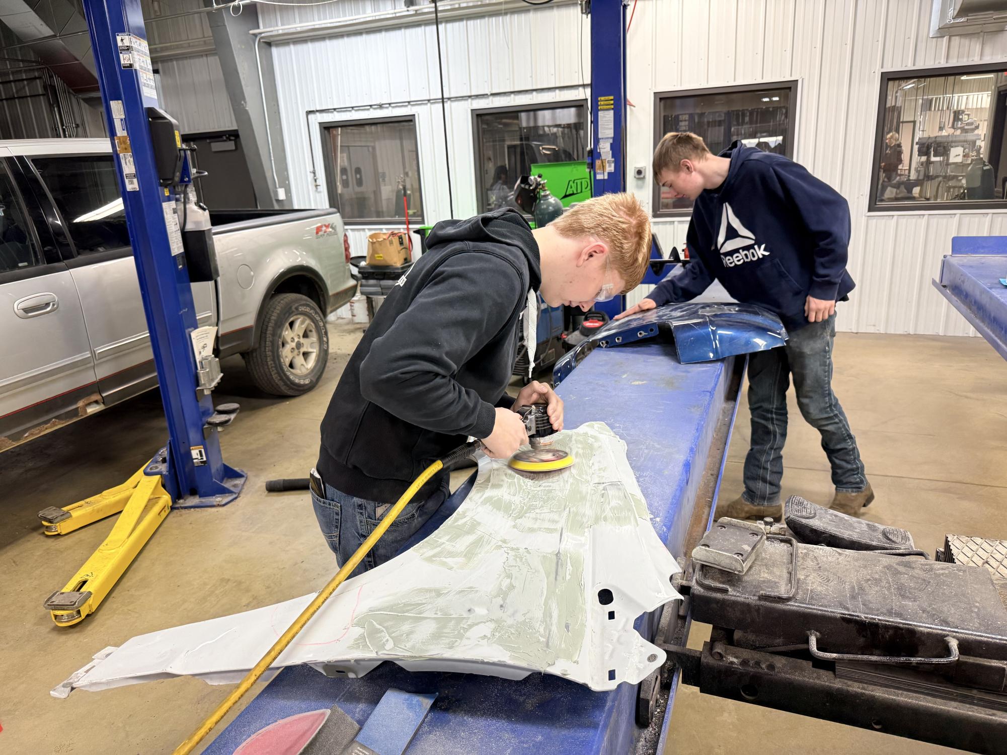 Junior Alex Schroeder sanding down the Bondo on his fender