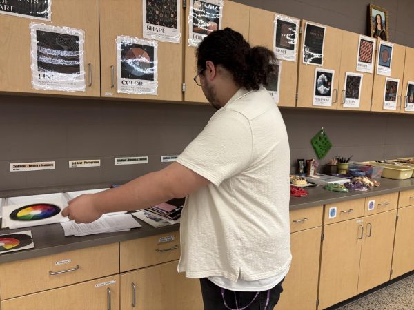 Mr. Santiago sorting through art projects. 