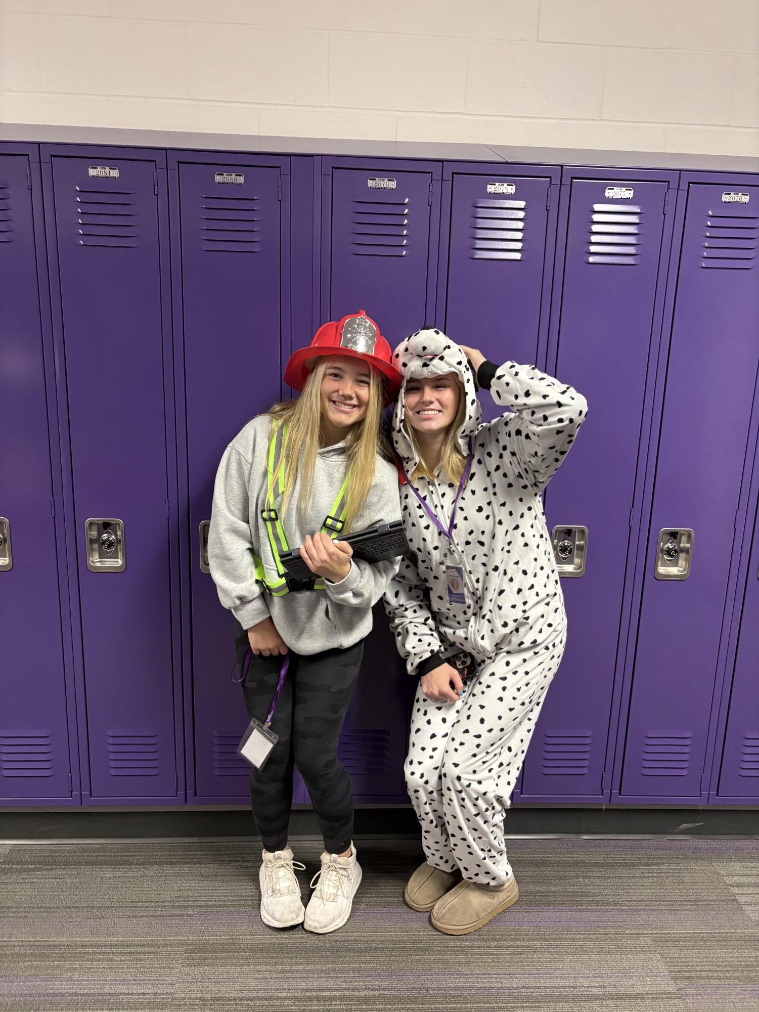 Seniors Maddi Olson and Brooklyn Lewis dress up as a firefighter and a fire dog for Halloween.
