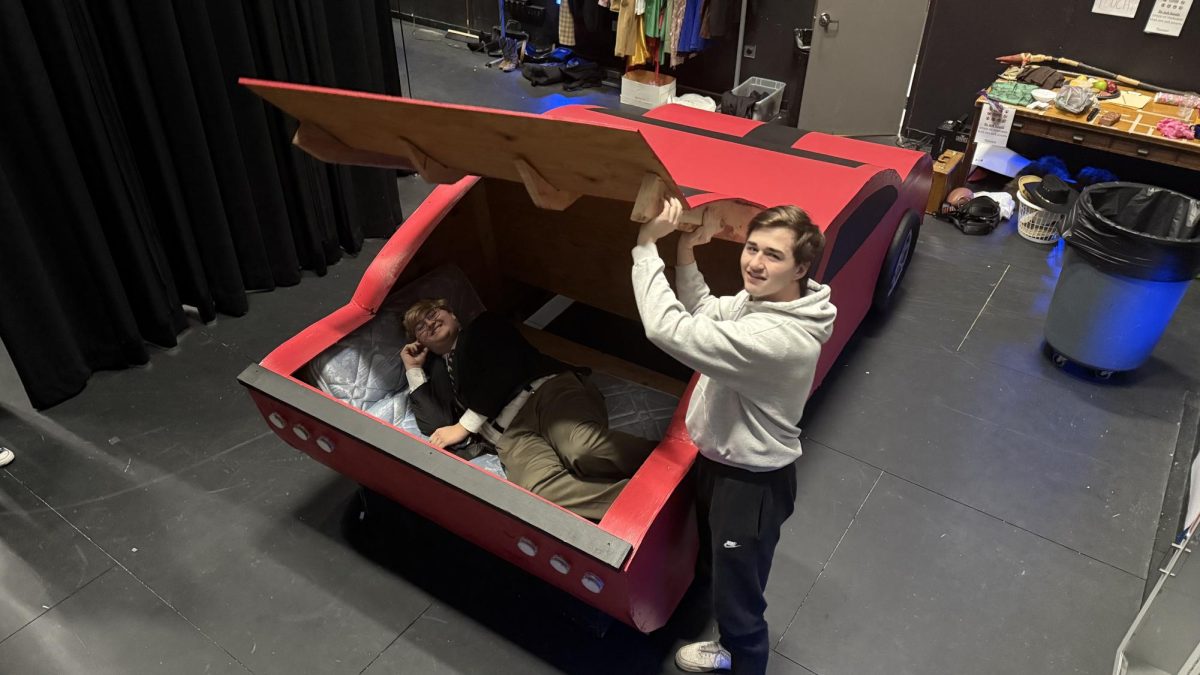 CAR-NAPPED? Stage crew lead Tyson Goold  and musical lead Everett Brown, both seniors, show how the kidnapping scene will play out.