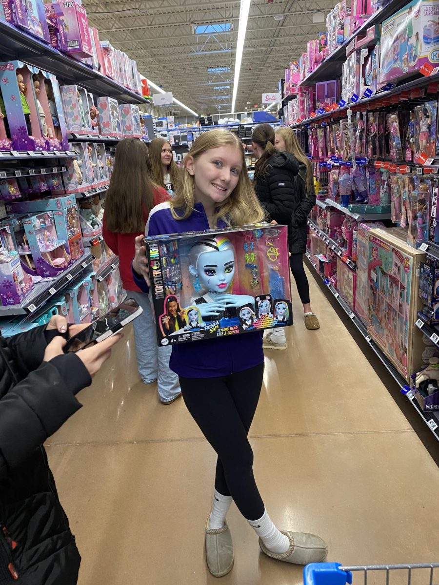 Keelie Dietz holding a Monster High Doll while shopping for FCCLA's Santa's Closet 