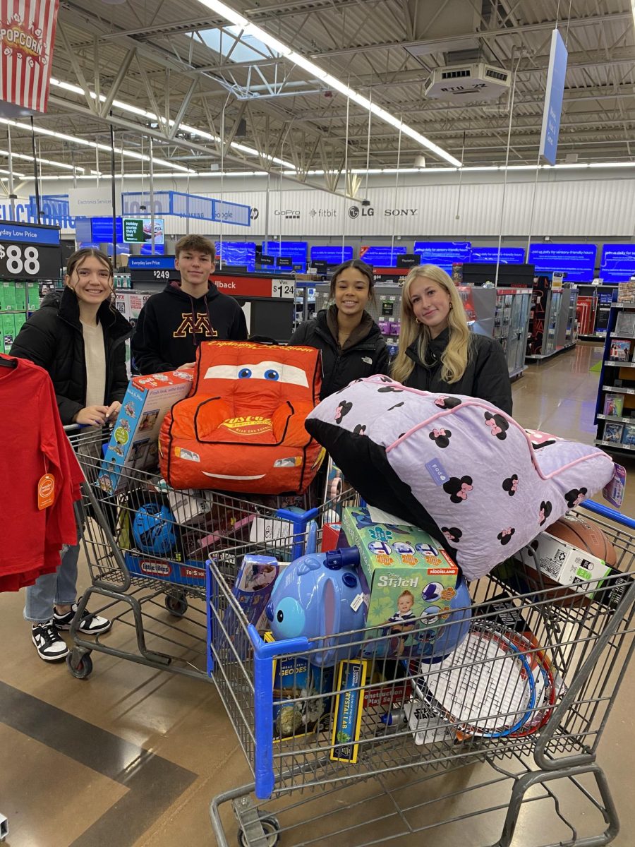 (Left to Right) Keira Sullivan, Charlie Weidman, Casey Johnson, and Kaylee Evans Cart full after shopping for FCCLA's Santa's Closet