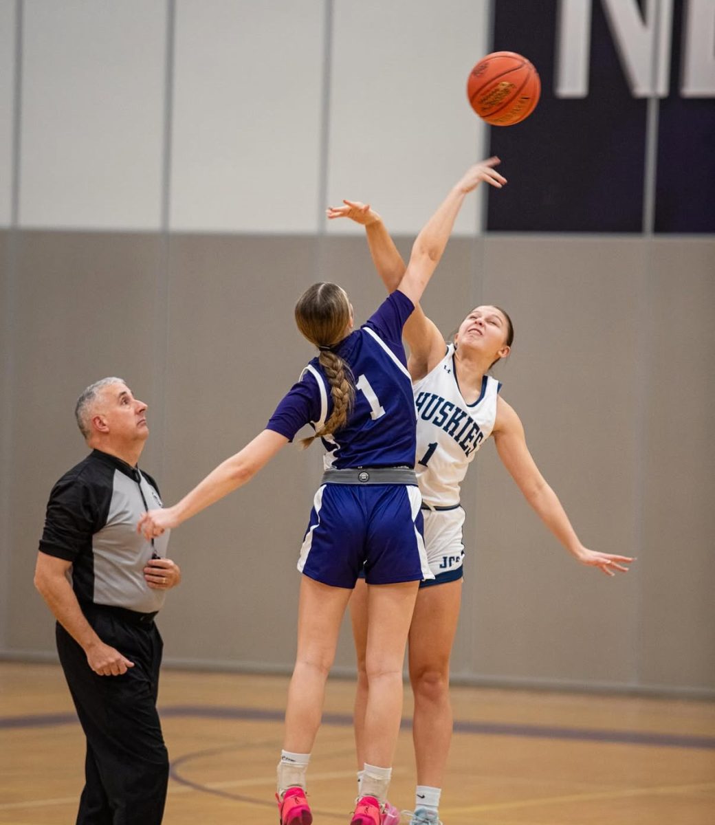 Leah Brustad jumping for the ball at the start of the game 