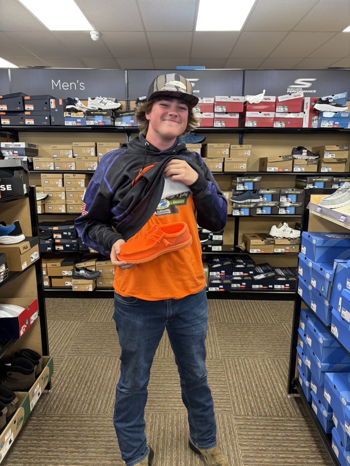 Trayton finds some bright orange Hey Dudes to go with his state trap shirt. 