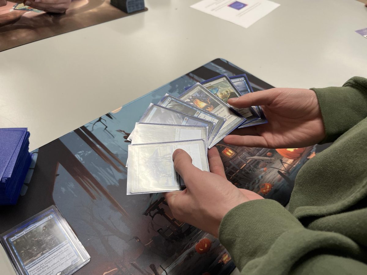 A hand of cards with terrible light glare