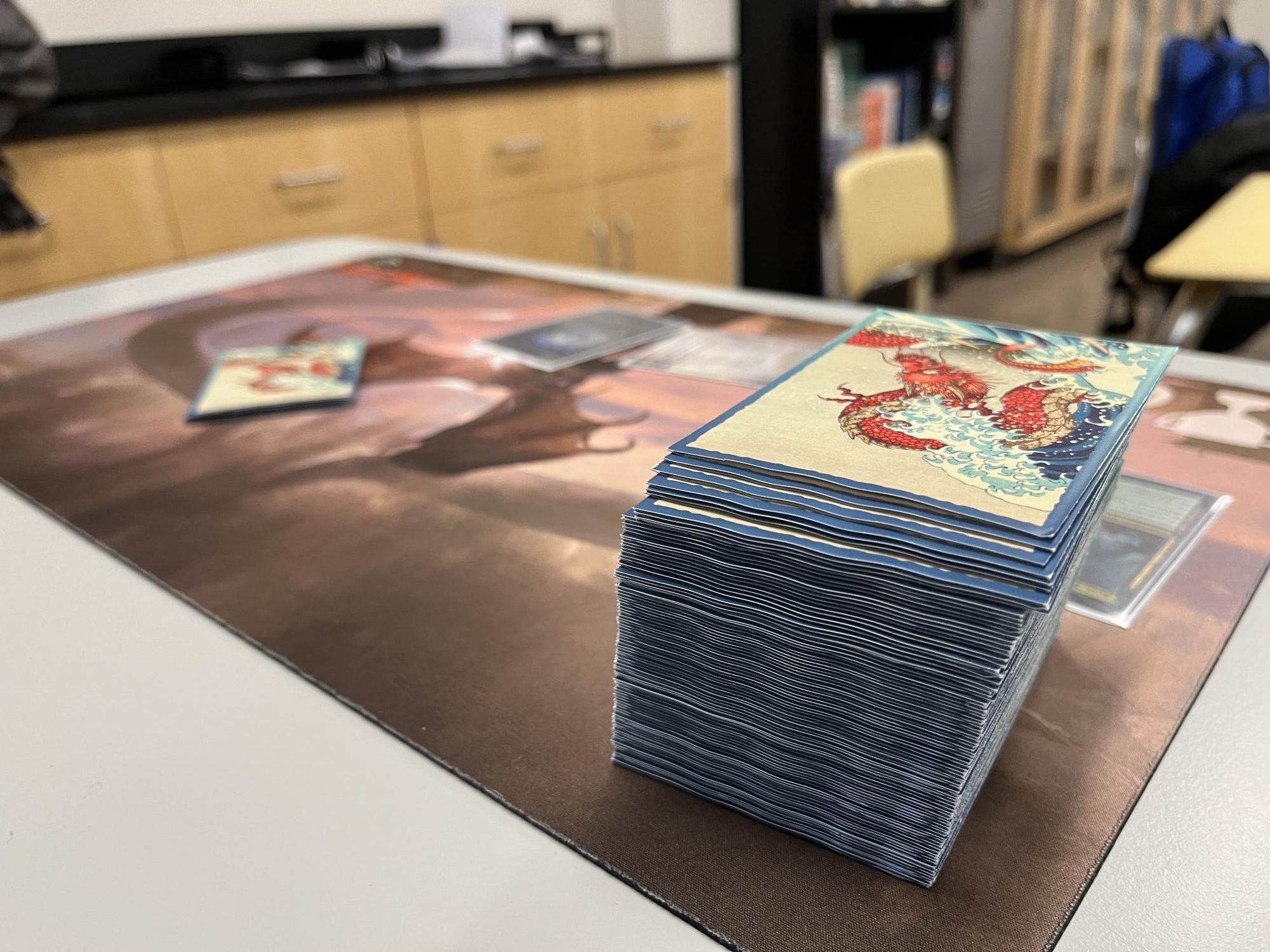 A playing mat set up with cards