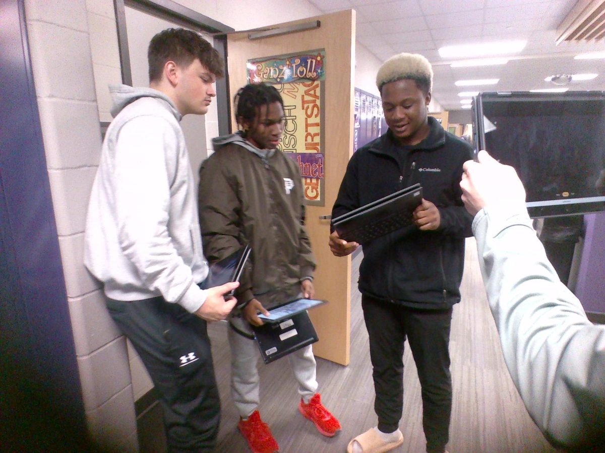 Brayden H. Lendale D. Methodius A. checking out photos.