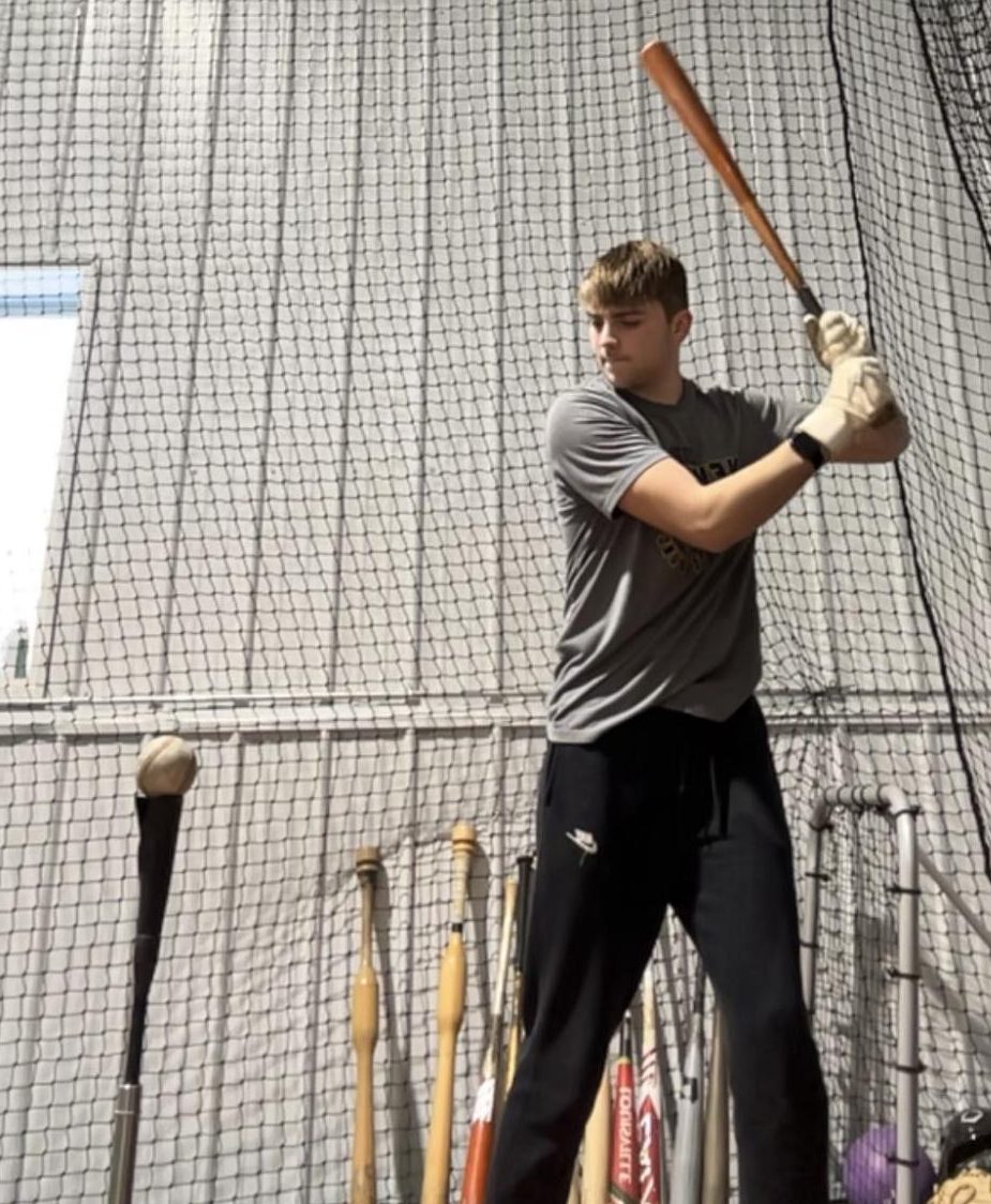 Ryan Rathmann practicing using a tee and a baseball