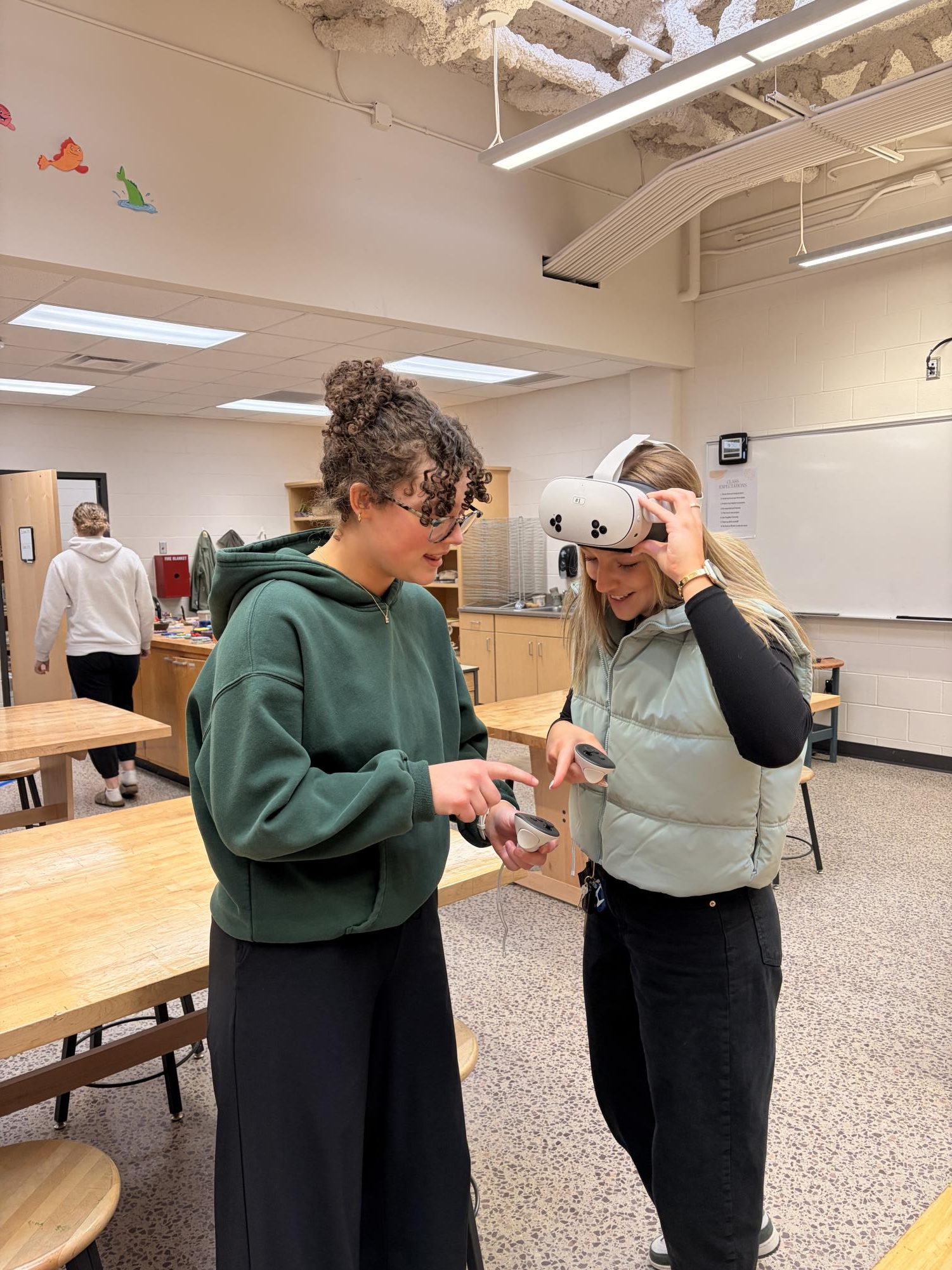 Naomi helping senior Stella Fischer figure out the VR set