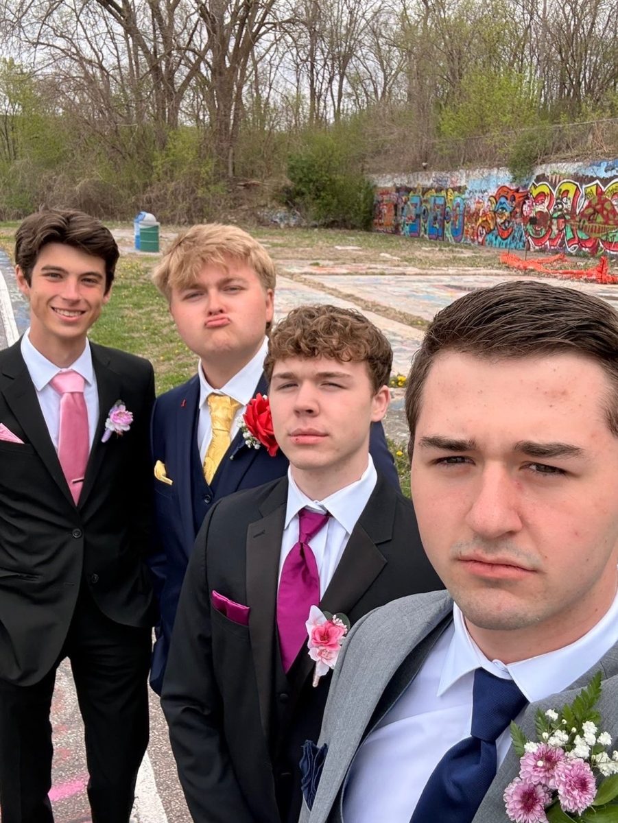Seniors Ryan Johnson, Tyson Goold, Everett Brown and Brady Seidl take prom pictures at the Graffiti Wall