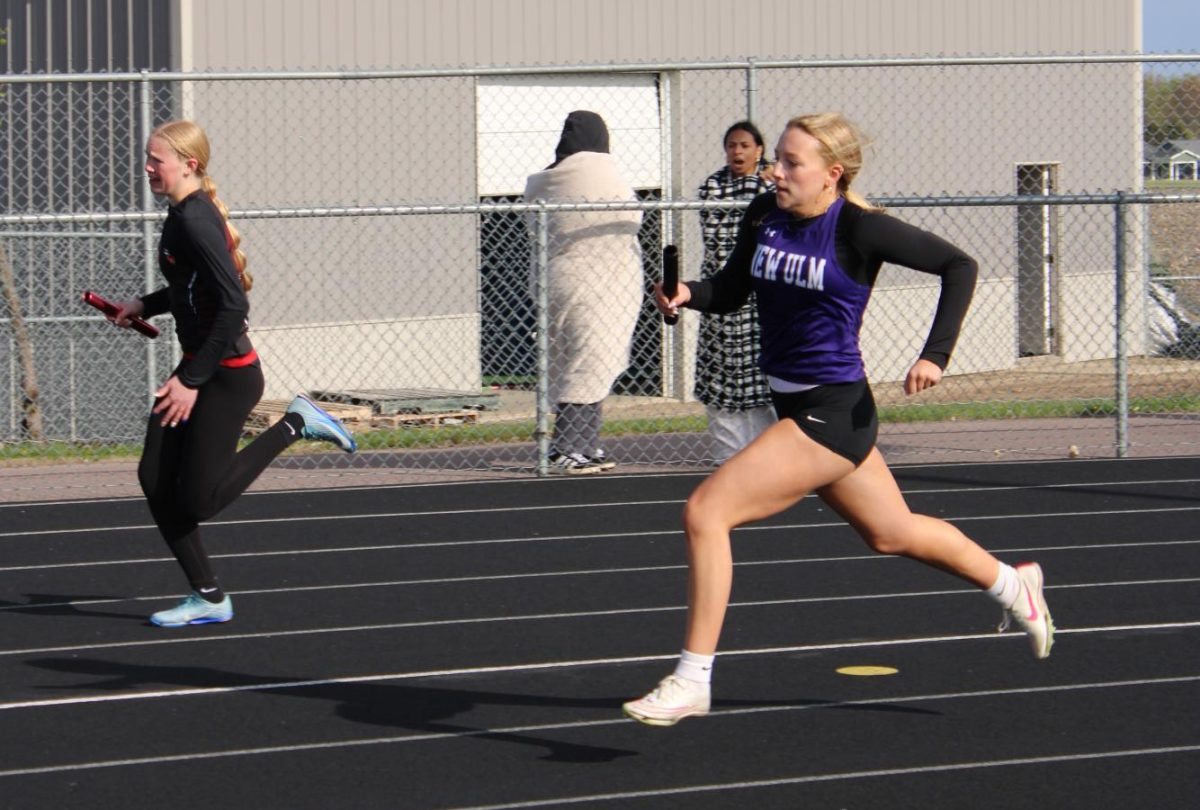 Stella Fischer gaining on an opposing runner in the girls 4x2