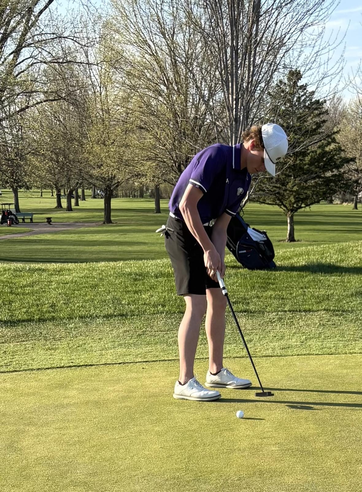 Colton Anderson putting the golf ball