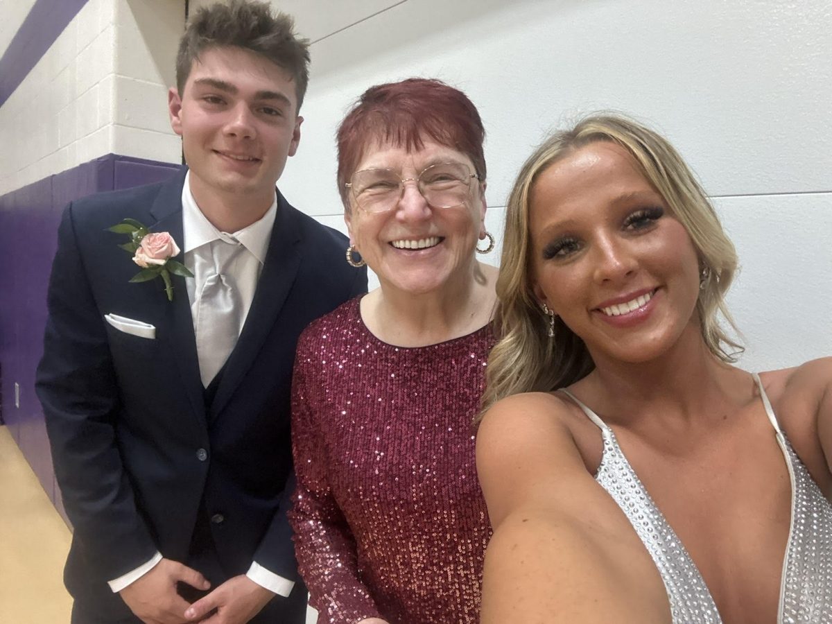 Two NUHS students take a picture with Mrs. Sullivan