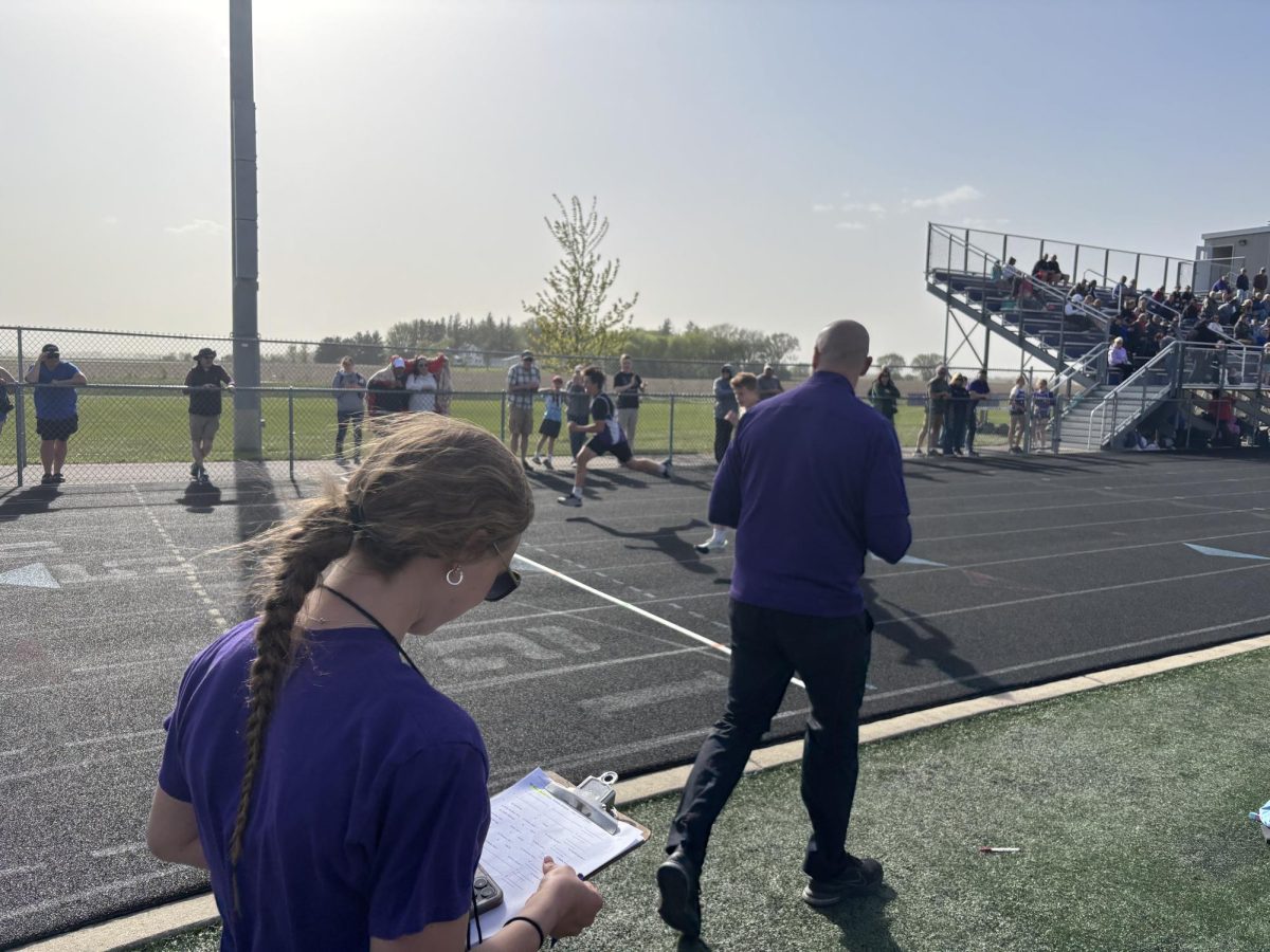 Isabelle Longtin and Coach Skogland help operate the middle school races