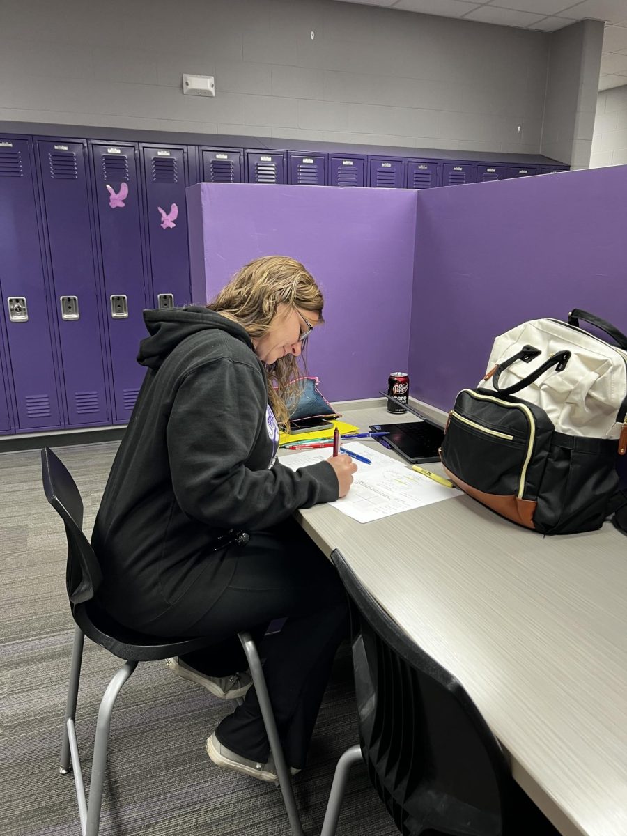 Para Jen Fleck working on homework to help her students succeed.