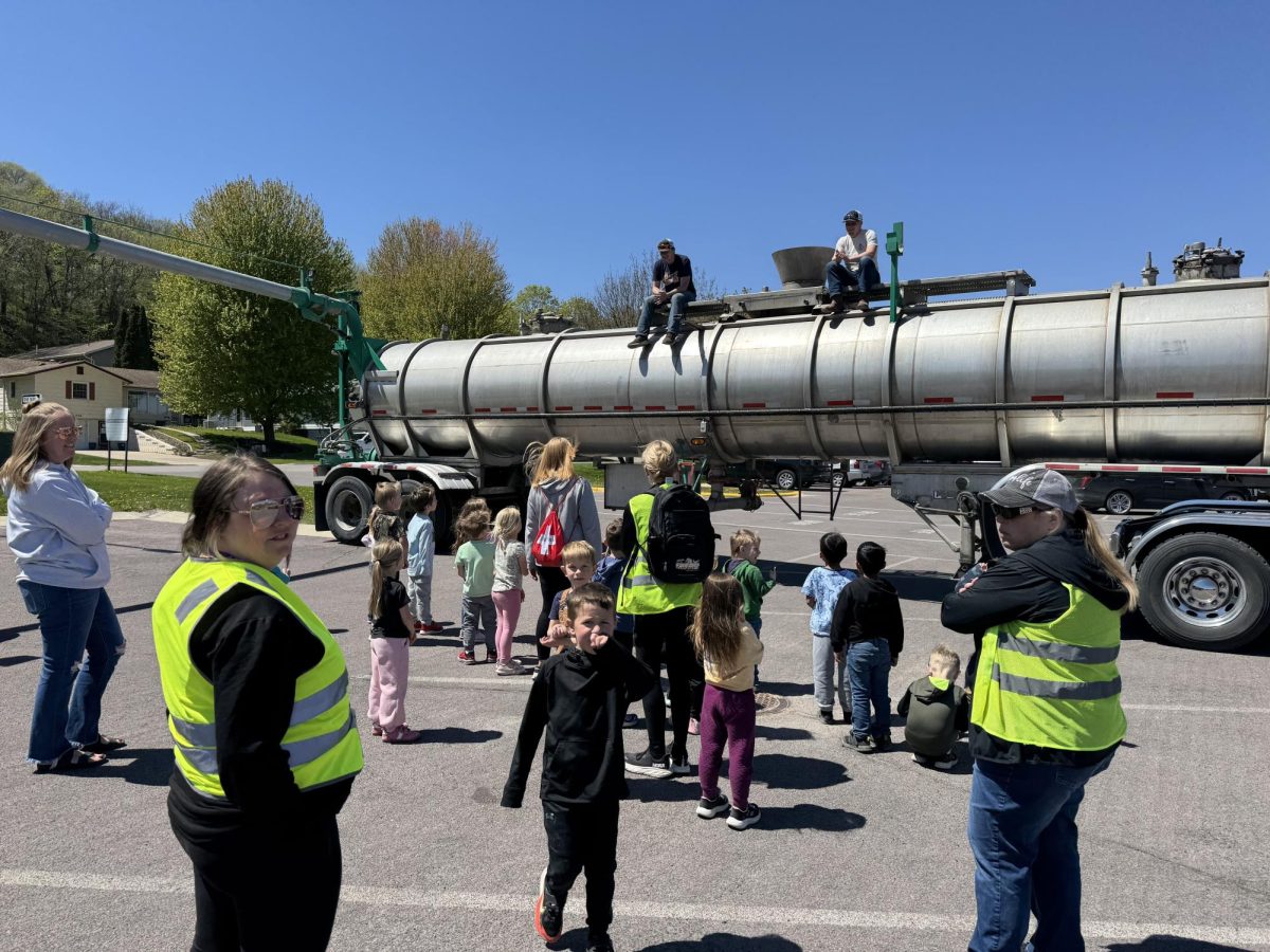 Logan Platz (right) and Spencer Drill on top of a semi trailer teaching kids. 